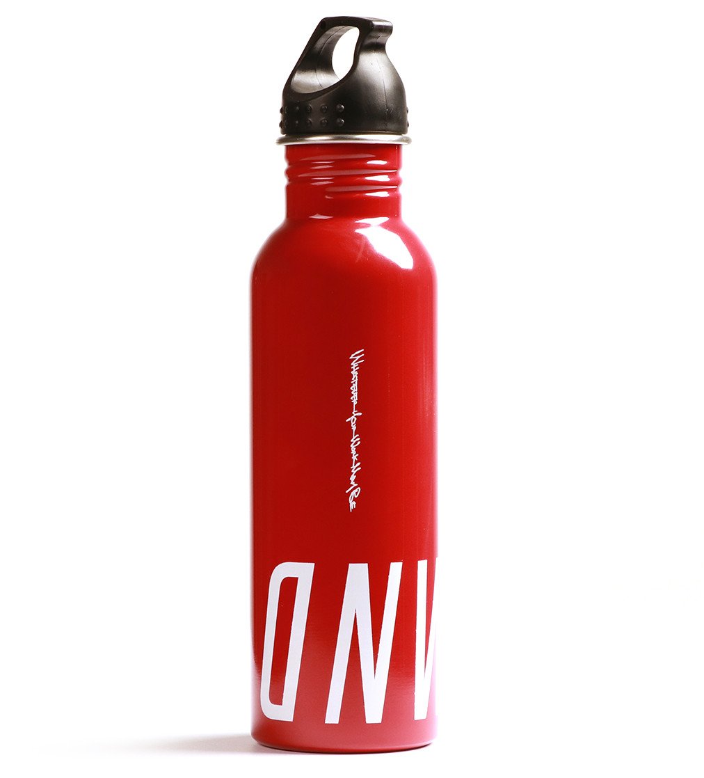 Photo of a red metal bottle with white lettering. Onward is printed on the bottom of the canister. White lettering "Whatever Your Work May Be" printed across the length of the bottle. 